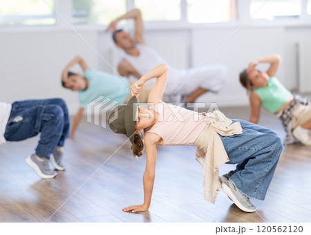 Preteen girl performing hip hop in group class for kids 120562120