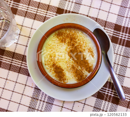 Rice pudding. Sweet dish made by cooking rice in milk and sugar, some recipes include vanilla 120562133