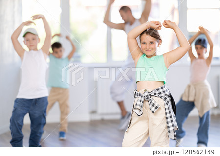 Tween girl dancer rehearsing krump dance at group workout Tween girl dancer rehearsing krump dance at group workout 120562139