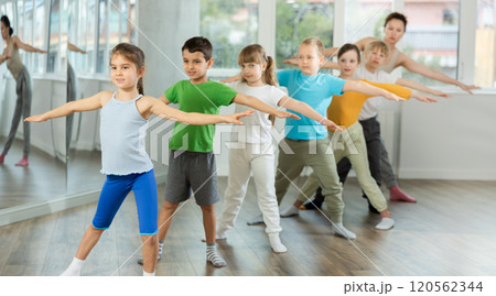 Group of children warming up before dance class Group of children warming up before dance class 120562344
