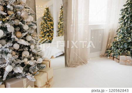 Gifts under a decorated Christmas tree in the living room. Gifts under a decorated Christmas tree in the living room. 120562843