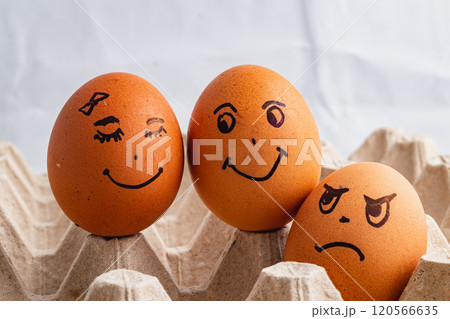 Happy couple of eggs smiling, envious angry and jealous stranger on the side 120566635