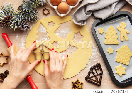 Pastry chef making christmas cookies using dough cutters 120567381