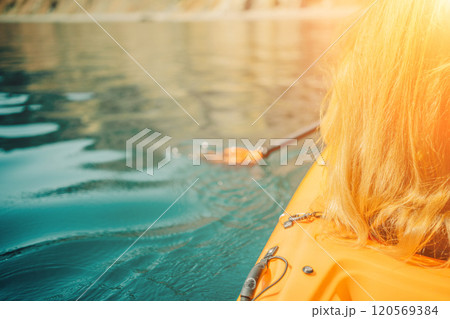 Kayak paddle sea vacation. Person paddles with orange paddle oar on kayak in sea. Leisure active lifestyle recreation activity rest tourism travel 120569384