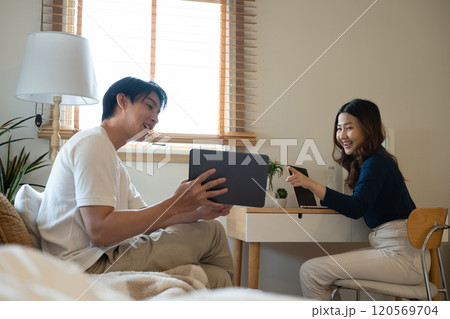 Cheerful adult couple enjoying a relaxed moment together at home 120569704