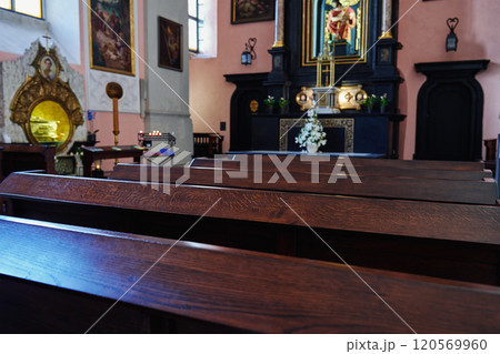 Interior of catholic church with wooden pews and altar in background. Place for praying in Cathedral 120569960