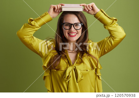 smiling healthy woman in green blouse and glasses on green smiling healthy woman in green blouse and glasses on green 120570938