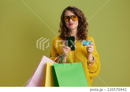 female in sweater and sunglasses using phone isolated on green female in sweater and sunglasses using phone isolated on green 120570942