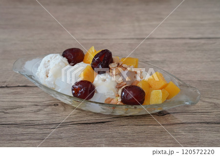 top view Coconut milk ice cream topped with coconut jelly, nuts, dried puttha, and welded in a glass bowl, on wooden floor background, object, food, dessert, sweet, copy space 120572220