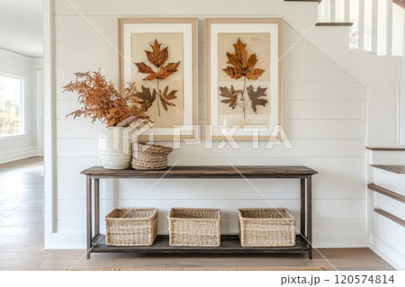 Rustic Entryway with Framed Botanical Prints, Wicker Baskets, and a Vase with Dried Foliage 120574814