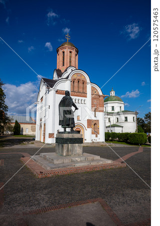 A scenic view of historic churches surrounded by greenery under a vibrant blue sky with scattered clouds. The architecture highlights cultural heritage and peaceful natural surroundings. 120575463