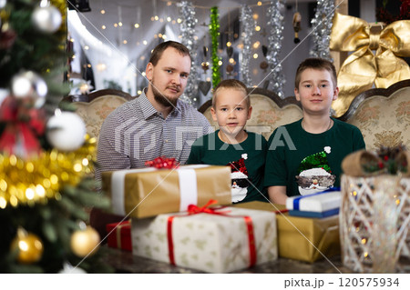 Happy father with children celebrating Christmas and giving each other gifts Happy father with children celebrating Christmas and giving each other gifts 120575934