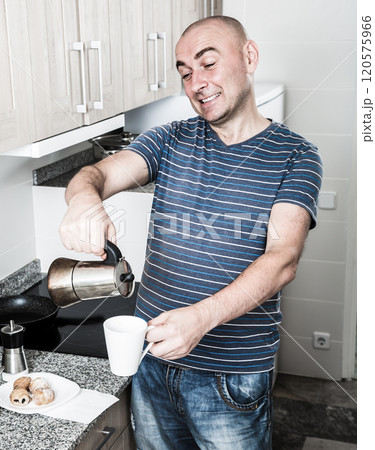 European guy pours coffee into cup of coffee pot European guy pours coffee into cup of coffee pot 120575966