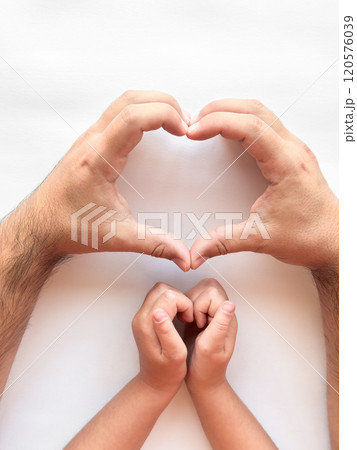 Adult and child hands forming heart shape on white background 120576039