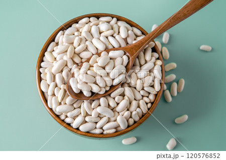 Kidney beans in a wooden bowl over pastel mint background. Kidney beans in a wooden bowl over pastel mint background. 120576852