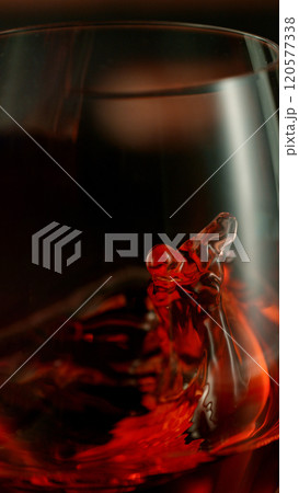 Close-up of red wine pouring into glass , freeze motion. 120577338