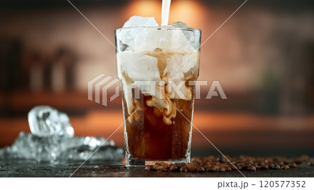 Freeze Motion Shot of Pouring Milk into Coffee in a Cafe Freeze Motion Shot of Pouring Milk into Coffee in a Cafe 120577352