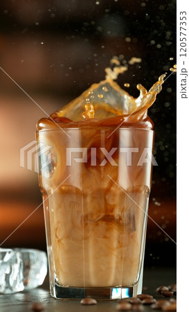 Macro Shot of Splashing Ice Cube into Coffee, Close-up 120577353