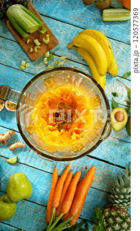 Fresh fruit and vegetables smoothie blended in blender, top view. Healthy eating concept. Freeze motion. 120577369