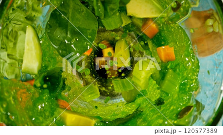 Fresh fruit and vegetables smoothie blended in blender, top view. Healthy eating concept. Freeze motion. 120577389