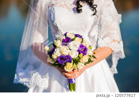 The bride with a wedding bouquet of roses The bride with a wedding bouquet of roses 120577617