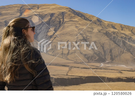 Young tourist with sunglasses looking at the scenery of Northern Argentina. 120580026