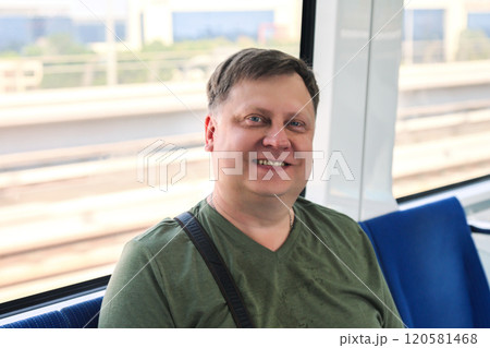 A man aged 45-50 goes home from work by metro, using public city transport A man aged 45-50 goes home from work by metro, using public city transport 120581468