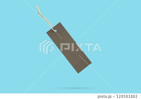 Blank price tag tied with string float on blue background 120581881