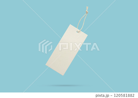 Blank price tag tied with string float on blue background Blank price tag tied with string float on blue background 120581882