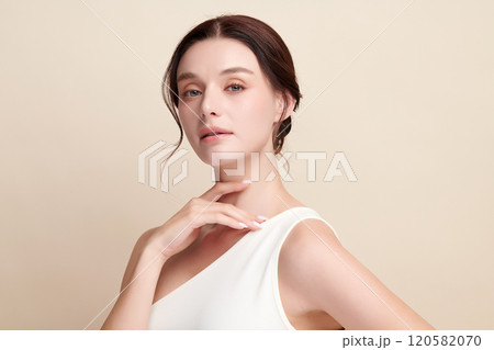 Beautiful young woman with clean fresh skin on beige background, Face care, Facial treatment, Cosmetology, beauty and spa, women portrait. 120582070