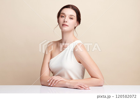 Beautiful young woman with clean fresh skin on beige background, Face care, Facial treatment, Cosmetology, beauty and spa, women portrait. Beautiful young woman with clean fresh skin on beige background, Face care, Facial treatment, Cosmetology, beauty and spa, women portrait. 120582072