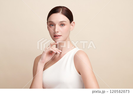 Beautiful young woman with clean fresh skin on beige background, Face care, Facial treatment, Cosmetology, beauty and spa, women portrait. 120582073