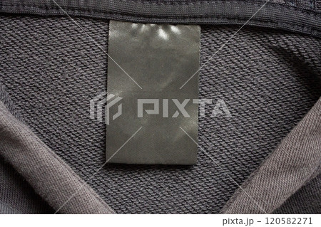 Blank black laundry care clothes label on black fabric texture background Blank black laundry care clothes label on black fabric texture background 120582271