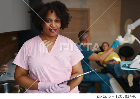Portrait of Smiling Dental Professional in Clinic Room Portrait of Smiling Dental Professional in Clinic Room 120582446