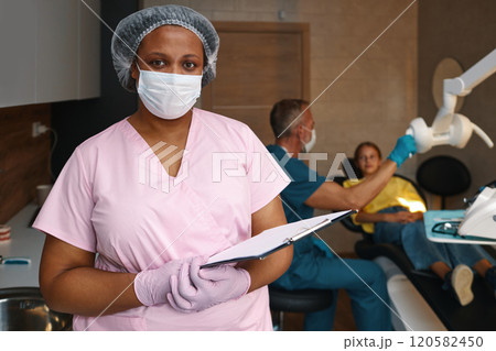 Dentist Assisting Patient During Dental Check-Up 120582450