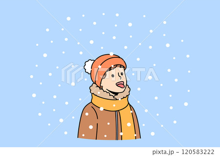 Litle boy opens mouth and eating snow, enjoying winter weather and new year mood 120583222
