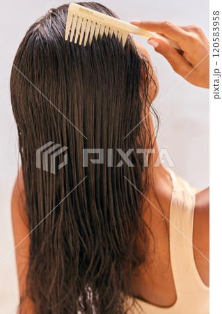 Hair Care Woman Combing Long Wet Hair for Smooth and Healthy Look 120583958
