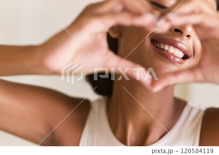 Dental Care. Woman Framing Face With Hands Showing Heart Gesture of Joy Dental Care. Woman Framing Face With Hands Showing Heart Gesture of Joy 120584119