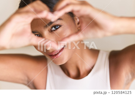 Healthy Eyes. Woman Framing Face with Hands in Heart-Shaped Gesture 120584125
