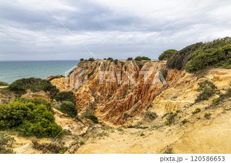 Praia da Marinha Beach among rock islets and cliffs seen from Seven Hanging Valleys Trail, Algarve, Portugal Praia da Marinha Beach among rock islets and cliffs seen from Seven Hanging Valleys Trail, Algarve, Portugal 120586653