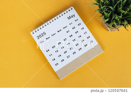 May 2025 desk calendar on yellow background. Directly above. Flat lay 120587681