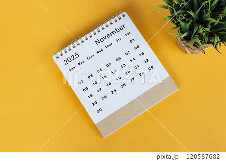 November 2025 desk calendar on yellow background. Directly above. Flat lay November 2025 desk calendar on yellow background. Directly above. Flat lay 120587682