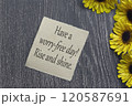 Motivational on brown note with gerbera yellow flower on wooden surface. 120587691