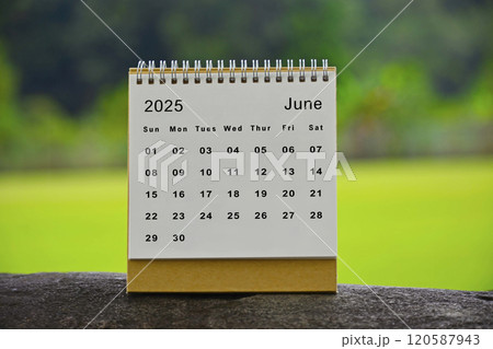 June 2025 white calendar with green blurred background - New year concept June 2025 white calendar with green blurred background - New year concept 120587943