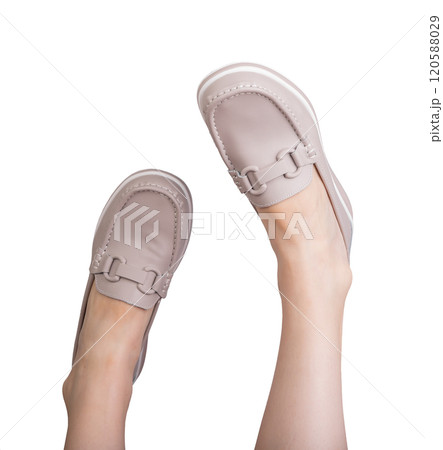 Feet in stylish leather loafers, a chic and comfortable pair of slip on shoes. Elegant, modern 120588029