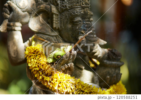 Sculpture of a temple with flowers and incense for ritual offerings on the popular tourist island of Bali. Sculpture of a temple with flowers and incense for ritual offerings on the popular tourist island of Bali. 120588251