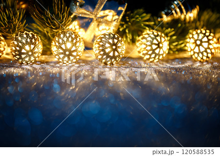 Beautiful Christmas decorations displayed with a gift box in the background Beautiful Christmas decorations displayed with a gift box in the background 120588535