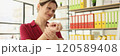 Tired woman employee kneads wrist and feels pain in office 120589408