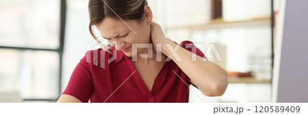 Woman worker suffers from pain in neck at office workplace 120589409