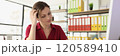 Female office employee with hard migraine at workplace 120589410